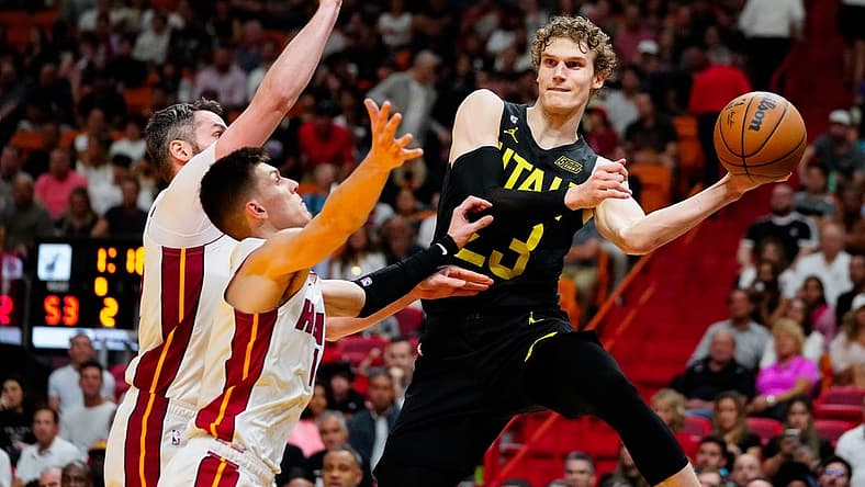 Mar 13, 2023; Miami, Florida, USA; Utah Jazz forward Lauri Markkanen (23) throws a pass as Miami Heat guard Tyler Herro (14) defends during the second quarter at Miami-Dade Arena. Mandatory Credit: Rich Storry-USA TODAY Sports