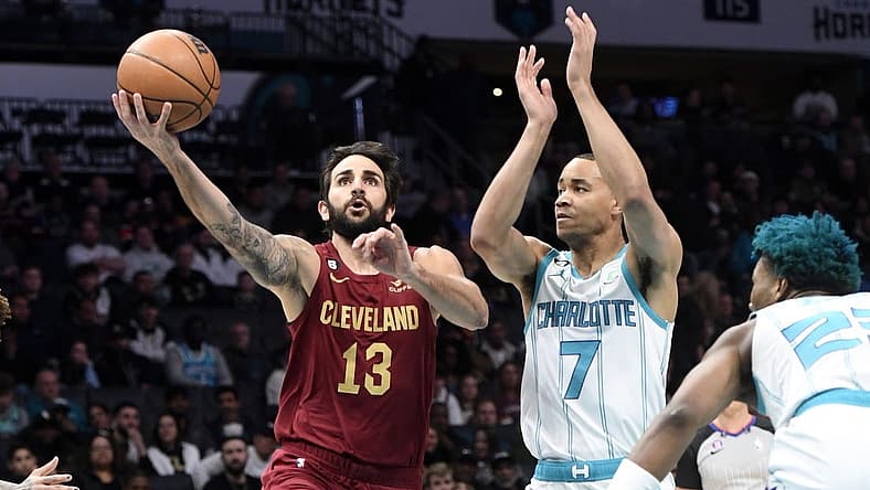 Mar 14, 2023; Charlotte, North Carolina, USA; Cleveland Cavaliers guard Ricky Rubio (13) drives past Charlotte Hornets guard Bryce McGowens (7) during the first half at the Spectrum Center. Mandatory Credit: Sam Sharpe-USA TODAY Sports