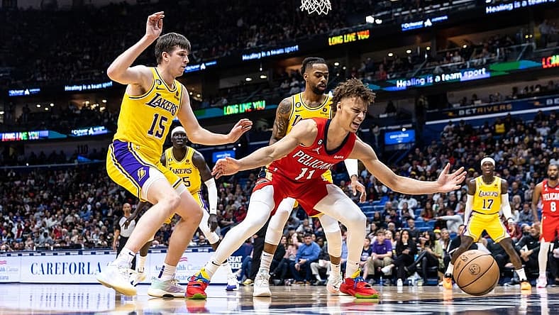 Mar 14, 2023; New Orleans, Louisiana, USA; New Orleans Pelicans guard Dyson Daniels (11) looses the ball out of bounds against Los Angeles Lakers guard Austin Reaves (15) during the first half at Smoothie King Center. Mandatory Credit: Stephen Lew-USA TODAY Sports