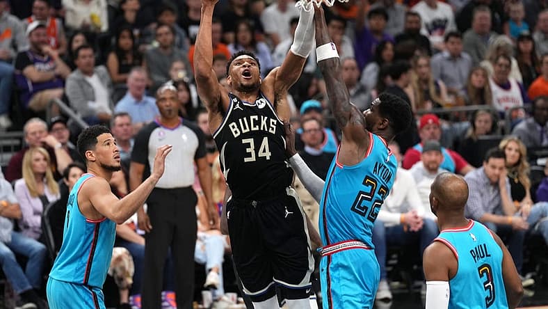 Mar 14, 2023; Phoenix, Arizona, USA; Milwaukee Bucks forward Giannis Antetokounmpo (34) shoots over Phoenix Suns center Deandre Ayton (22) during the first half at Footprint Center. Mandatory Credit: Joe Camporeale-USA TODAY Sports