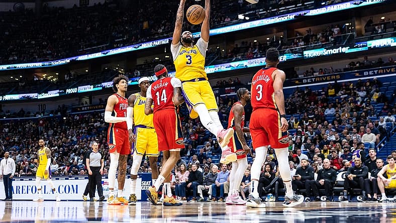 Mar 14, 2023; New Orleans, Louisiana, USA; Los Angeles Lakers forward Anthony Davis (3) dunks the ball against New Orleans Pelicans forward Brandon Ingram (14) during the second half at Smoothie King Center. Mandatory Credit: Stephen Lew-USA TODAY Sports