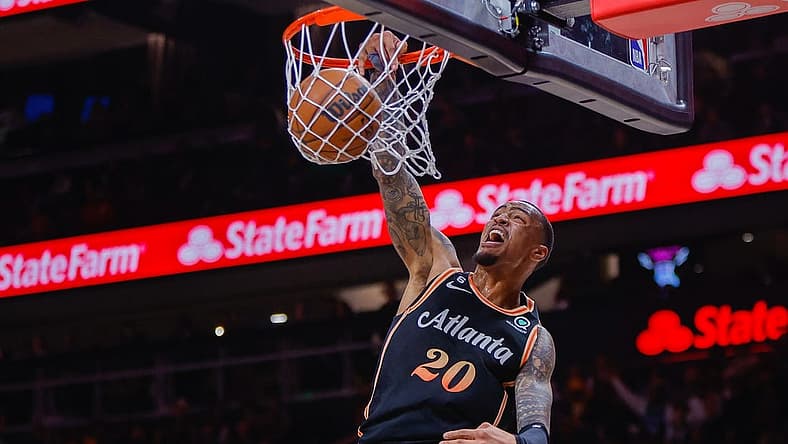 Mar 17, 2023; Atlanta, Georgia, USA; Atlanta Hawks forward John Collins (20) dunks against the Golden State Warriors in the first quarter at State Farm Arena. Mandatory Credit: Brett Davis-USA TODAY Sports