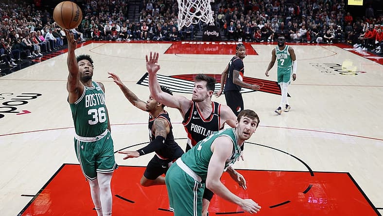 Mar 17, 2023; Portland, Oregon, USA; Boston Celtics point guard Marcus Smart (36) shoots the ball against Portland Trail Blazers shooting guard Anfernee Simons (1, center) and power forward Drew Eubanks (24) uring the first half at Moda Center. Mandatory Credit: Soobum Im-USA TODAY Sports