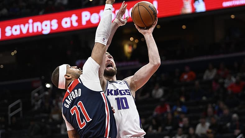 Mar 18, 2023; Washington, District of Columbia, USA; Sacramento Kings forward Domantas Sabonis (10) shoots over Washington Wizards center Daniel Gafford (21) during the first half at Capital One Arena. Mandatory Credit: Brad Mills-USA TODAY Sports