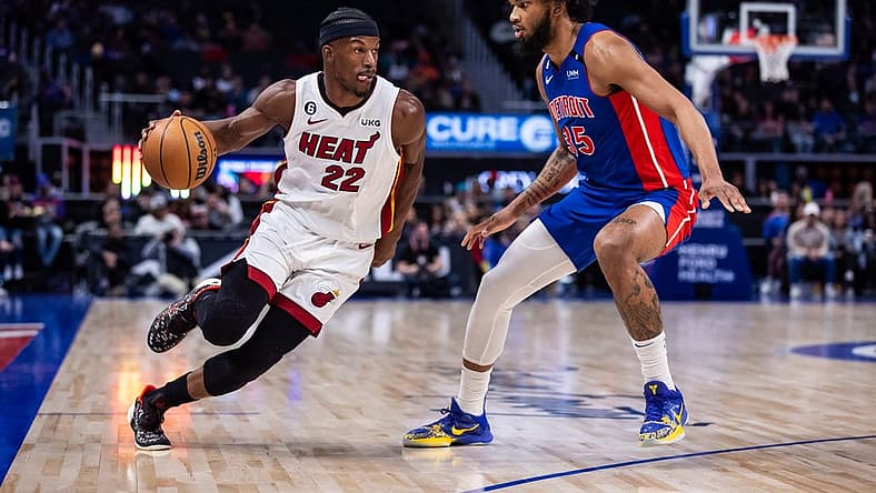Mar 19, 2023; Detroit, Michigan, USA; Miami Heat forward Jimmy Butler (22) drives to the basket against Detroit Pistons forward Marvin Bagley III (35) in the first quarter at Little Caesars Arena. Mandatory Credit: Allison Farrand-USA TODAY Sports