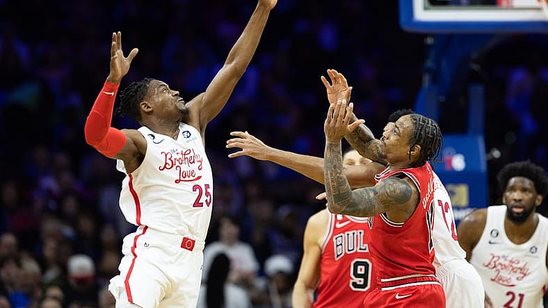 Mar 20, 2023; Philadelphia, Pennsylvania, USA; Philadelphia 76ers forward Danuel House Jr. (25) tips the ball past Chicago Bulls forward DeMar DeRozan (11) during the second quarter at Wells Fargo Center. Mandatory Credit: Bill Streicher-USA TODAY Sports