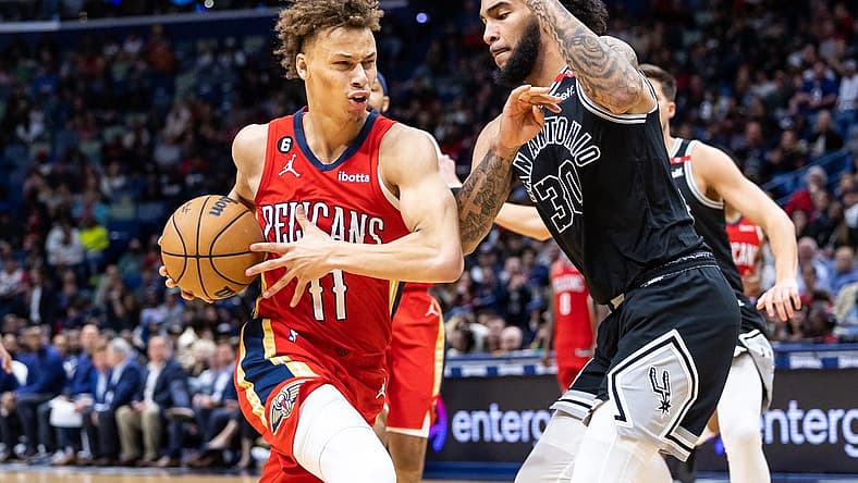 Mar 21, 2023; New Orleans, Louisiana, USA; New Orleans Pelicans guard Dyson Daniels (11) dribbles against San Antonio Spurs forward Julian Champagnie (30) during the second half at Smoothie King Center. Mandatory Credit: Stephen Lew-USA TODAY Sports