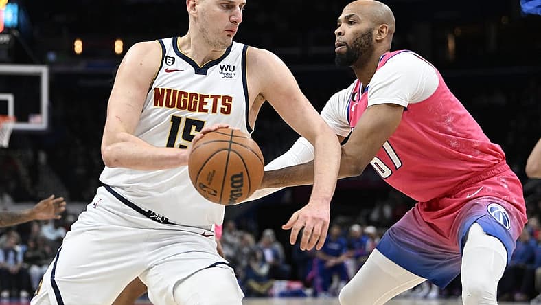 Mar 22, 2023; Washington, District of Columbia, USA; Denver Nuggets center Nikola Jokic (15) dribbles as Washington Wizards forward Taj Gibson (67) defends during the first half at Capital One Arena. Mandatory Credit: Brad Mills-USA TODAY Sports