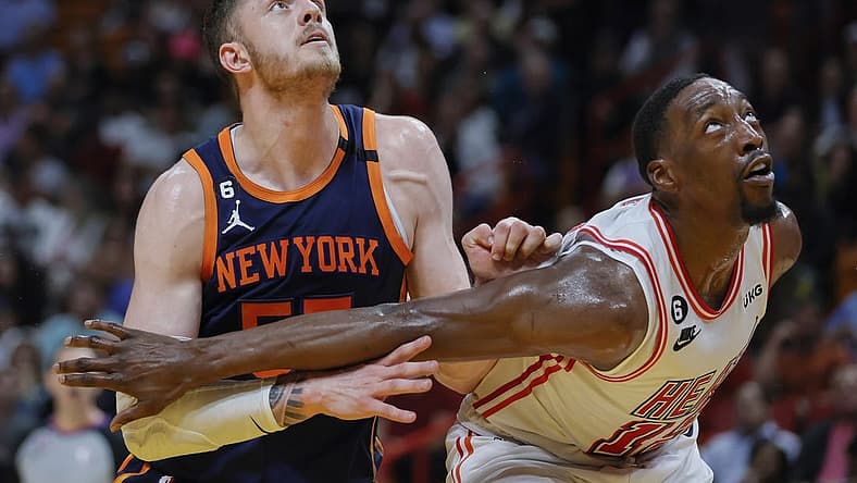 Mar 22, 2023; Miami, Florida, USA; New York Knicks center Isaiah Hartenstein (55) and Miami Heat center Bam Adebayo (13) defend during a free-throw attempt in the second quarter at Miami-Dade Arena. Mandatory Credit: Sam Navarro-USA TODAY Sports