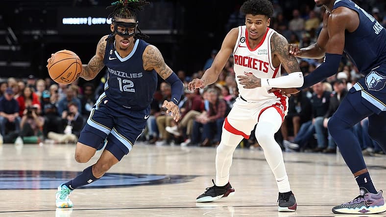 Mar 22, 2023; Memphis, Tennessee, USA; Memphis Grizzlies guard Ja Morant (12) drives to the basket as Houston Rockets guard Jalen Green (4) defends during the second half at FedExForum. Mandatory Credit: Petre Thomas-USA TODAY Sports