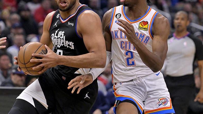 Mar 23, 2023; Los Angeles, California, USA; Los Angeles Clippers guard Eric Gordon (10) has the ball stropped by Oklahoma City Thunder guard Shai Gilgeous-Alexander (2) as he moves to the basket in the first half at Crypto.com Arena. Mandatory Credit: Jayne Kamin-Oncea-USA TODAY Sports