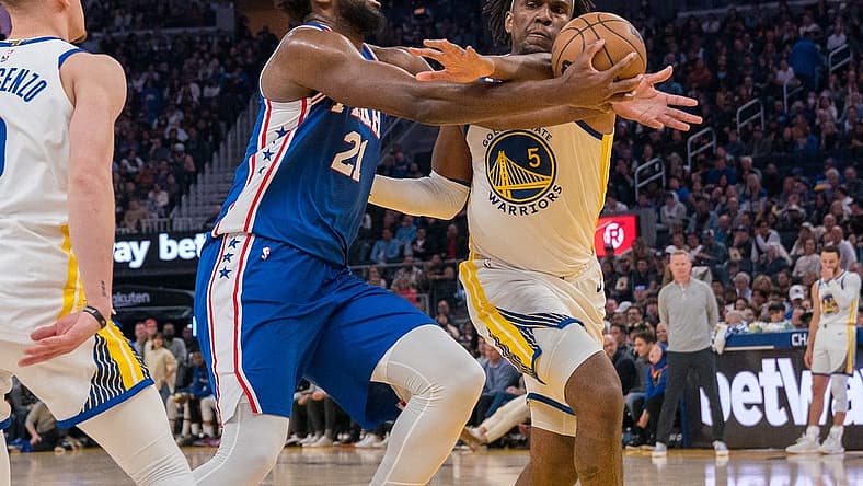 Mar 24, 2023; San Francisco, California, USA;  Philadelphia 76ers center Joel Embiid (21) is fouled in the act of shooting by Golden State Warriors forward Kevon Looney (5) during the second quarter at Chase Center. Mandatory Credit: Neville E. Guard-USA TODAY Sports