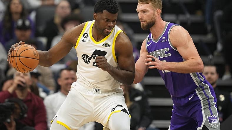 Mar 25, 2023; Sacramento, California, USA; Utah Jazz center Udoka Azubuike (left) dribbles against Sacramento Kings forward Domantas Sabonis (right) during the first quarter at Golden 1 Center. Mandatory Credit: Darren Yamashita-USA TODAY Sports