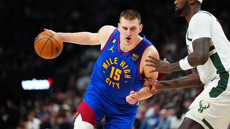 Mar 25, 2023; Denver, Colorado, USA; Denver Nuggets center Nikola Jokic (15) drives at Milwaukee Bucks forward Bobby Portis (9) during the second half at Ball Arena. Mandatory Credit: Ron Chenoy-USA TODAY Sports
