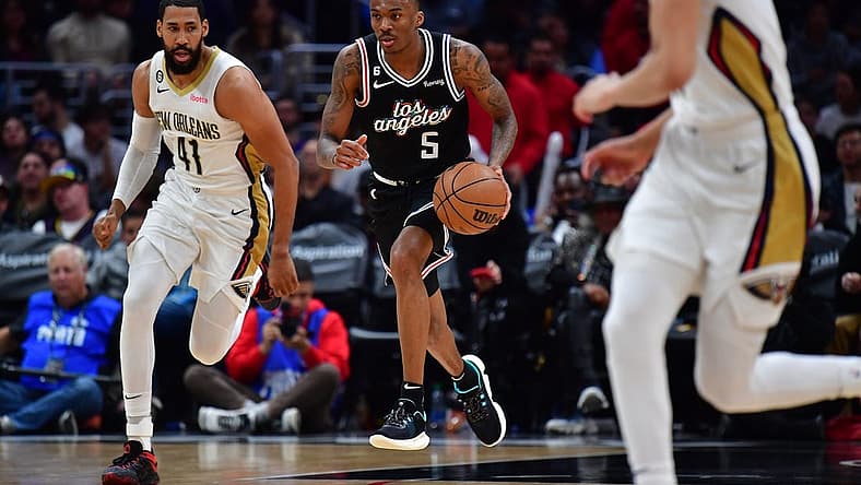 Mar 25, 2023; Los Angeles, California, USA; Los Angeles Clippers guard Bones Hyland (5) moves the ball ahead of New Orleans Pelicans forward Garrett Temple (41) during the second half at Crypto.com Arena. Mandatory Credit: Gary A. Vasquez-USA TODAY Sports