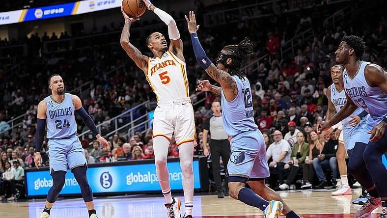 Mar 26, 2023; Atlanta, Georgia, USA; Atlanta Hawks guard Dejounte Murray (5) looks to shoot against Memphis Grizzlies guard Ja Morant (12) during the first half at State Farm Arena. Mandatory Credit: Dale Zanine-USA TODAY Sports