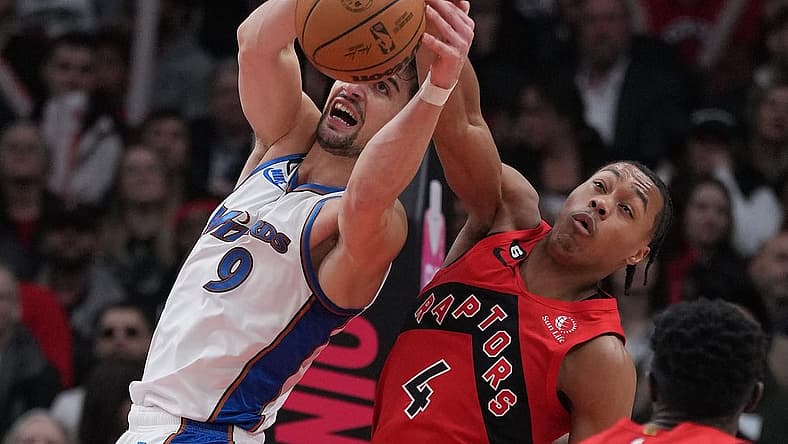 Mar 26, 2023; Toronto, Ontario, CAN; Toronto Raptors forward Scottie Barnes (4) battles for the ball with Washington Wizards forward Deni Avdija (9) during the second quarter at Scotiabank Arena. Mandatory Credit: Nick Turchiaro-USA TODAY Sports
