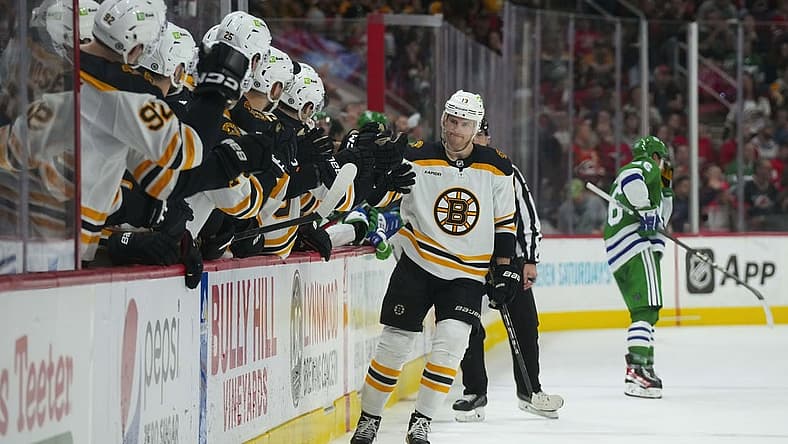 Mar 26, 2023; Raleigh, North Carolina, USA; Boston Bruins center Charlie Coyle (13) scores a shoot out goal against the Carolina Hurricanes (31) at PNC Arena. Mandatory Credit: James Guillory-USA TODAY Sports