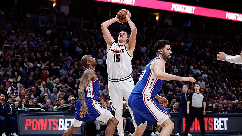 Mar 27, 2023; Denver, Colorado, USA; Denver Nuggets center Nikola Jokic (15) attempts a shot against Philadelphia 76ers forward P.J. Tucker (17) as forward Georges Niang (20) defends in the second quarter at Ball Arena. Mandatory Credit: Isaiah J. Downing-USA TODAY Sports