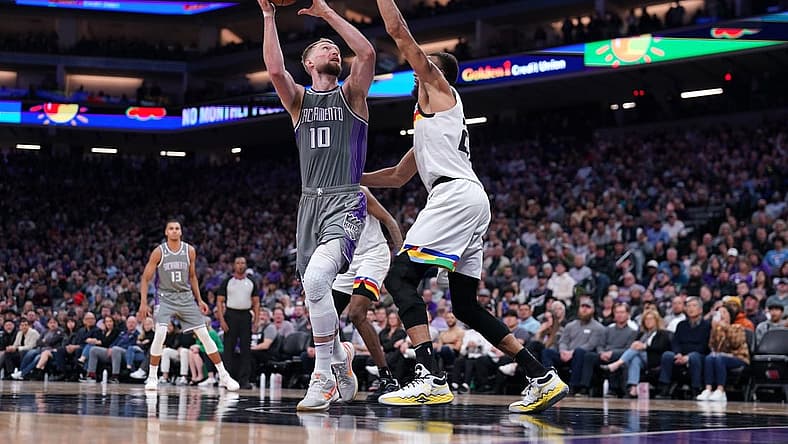 Mar 27, 2023; Sacramento, California, USA; Sacramento Kings forward Domantas Sabonis (10) shoots the ball next to Minnesota Timberwolves center Rudy Gobert (27) in the fourth quarter at the Golden 1 Center. Mandatory Credit: Cary Edmondson-USA TODAY Sports