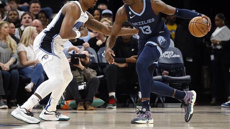 Mar 28, 2023; Memphis, Tennessee, USA; Memphis Grizzlies forward Jaren Jackson Jr. (13) dribbles to the basket as Orlando Magic center Wendell Carter Jr. (34) defends during the first half at FedExForum. Mandatory Credit: Petre Thomas-USA TODAY Sports