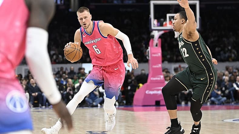Mar 28, 2023; Washington, District of Columbia, USA; Washington Wizards center Kristaps Porzingis (6) dribbles past Boston Celtics forward Grant Williams (12) during the second half at Capital One Arena. Mandatory Credit: Brad Mills-USA TODAY Sports