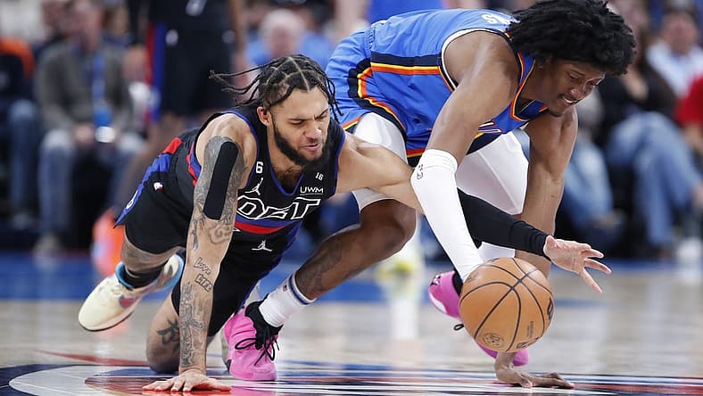 Mar 29, 2023; Oklahoma City, Oklahoma, USA;  Detroit Pistons forward Isaiah Livers (12) and Oklahoma City Thunder forward Jalen Williams (8) drive for a loose ball during the second quarter at Paycom Center. Mandatory Credit: Alonzo Adams-USA TODAY Sports