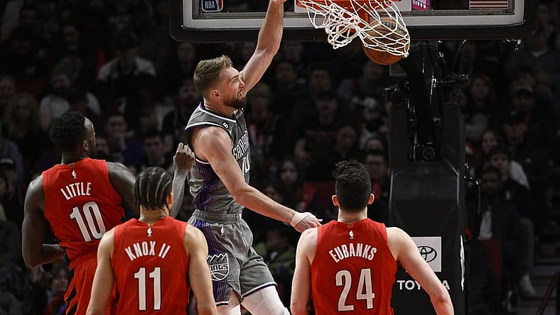 Mar 29, 2023; Portland, Oregon, USA; Sacramento Kings forward Domantas Sabonis (10) dunks the basketball during the first half against Portland Trail Blazers forward Nassir Little (10) at Moda Center. Mandatory Credit: Troy Wayrynen-USA TODAY Sports