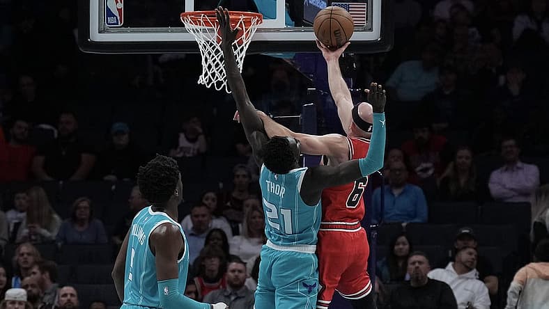 Mar 31, 2023; Charlotte, North Carolina, USA; Chicago Bulls guard Alex Caruso (6) shoots the ball over Charlotte Hornets forward JT Thor (21) in the first quarter at Spectrum Center. Mandatory Credit: David Yeazell-USA TODAY Sports