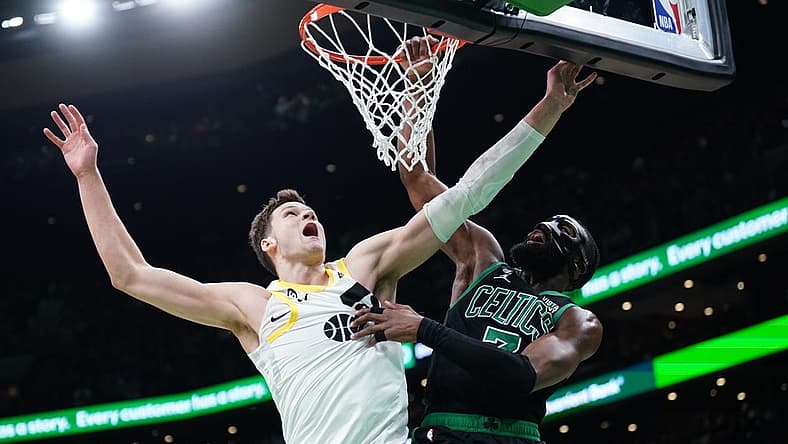 Mar 31, 2023; Boston, Massachusetts, USA; Boston Celtics guard Jaylen Brown (7) makes the basket against Utah Jazz center Walker Kessler (24) in the second quarter at TD Garden. Mandatory Credit: David Butler II-USA TODAY Sports