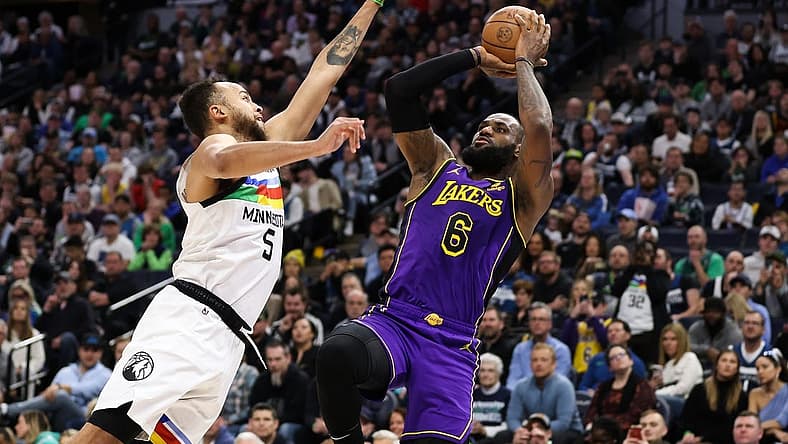 Mar 31, 2023; Minneapolis, Minnesota, USA; Los Angeles Lakers forward LeBron James (6) shoots while Minnesota Timberwolves forward Kyle Anderson (5) defends during the first quarter at Target Center. Mandatory Credit: Matt Krohn-USA TODAY Sports