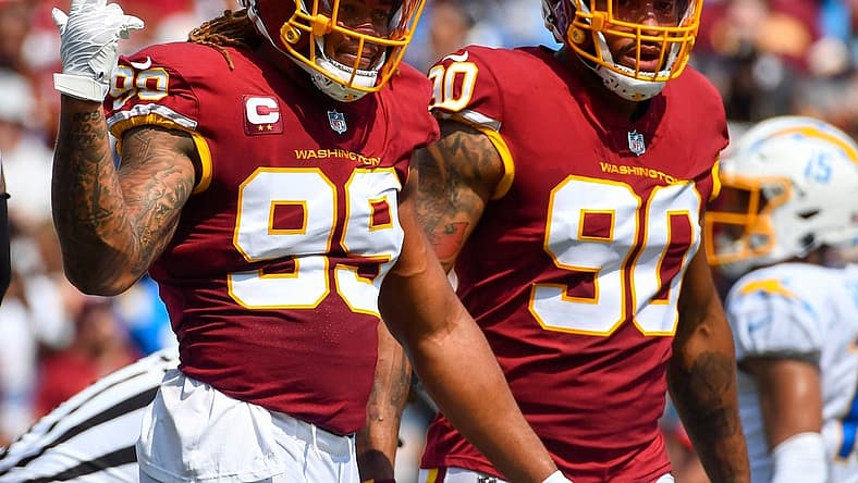 Sep 12, 2021; Landover, Maryland, USA; Washington Football Team defensive end Chase Young (99) and defensive end Montez Sweat (90) on the field against the Los Angeles Chargers during the first quarter at FedExField. Mandatory Credit: Brad Mills-USA TODAY Sports