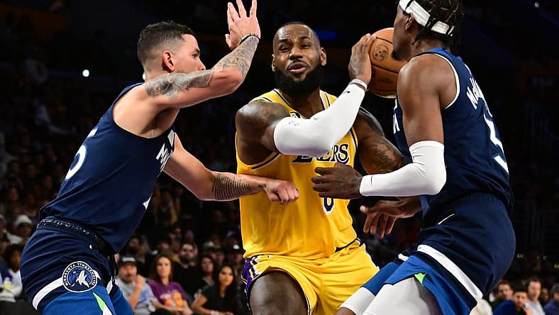 Oct 12, 2022; Los Angeles, California, USA; Los Angeles Lakers forward LeBron James (6) drives through Minnesota Timberwolves Jaden McDaniels (3) and Minnesota Timberwolves guard Austin Rivers (25) during the third quarter at Crypto.com Arena. Mandatory Credit: Richard Mackson-USA TODAY Sports