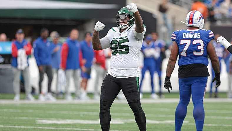 Nov 6, 2022; East Rutherford, New Jersey, USA; New York Jets defensive tackle Quinnen Williams (95) celebrates a defensive stop being Buffalo Bills offensive tackle Dion Dawkins (73) during the second half at MetLife Stadium. Mandatory Credit: Vincent Carchietta-USA TODAY Sports