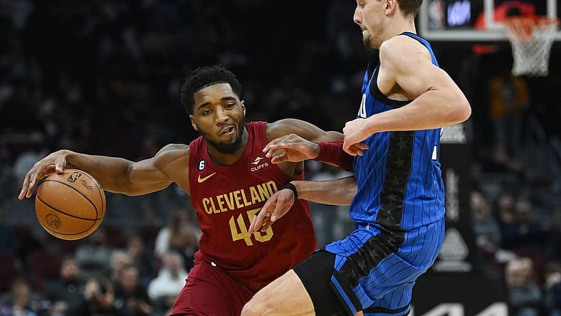 Dec 2, 2022; Cleveland, Ohio, USA; Orlando Magic forward Franz Wagner (22) defends Cleveland Cavaliers guard Donovan Mitchell (45) during the second half at Rocket Mortgage FieldHouse. Mandatory Credit: Ken Blaze-USA TODAY Sports