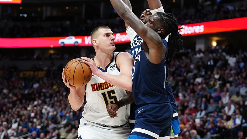 Feb 7, 2023; Denver, Colorado, USA; Minnesota Timberwolves forward Taurean Prince (12) and center Naz Reid (11) defend on Denver Nuggets center Nikola Jokic (15) in the second quarter at Ball Arena. Mandatory Credit: Ron Chenoy-USA TODAY Sports