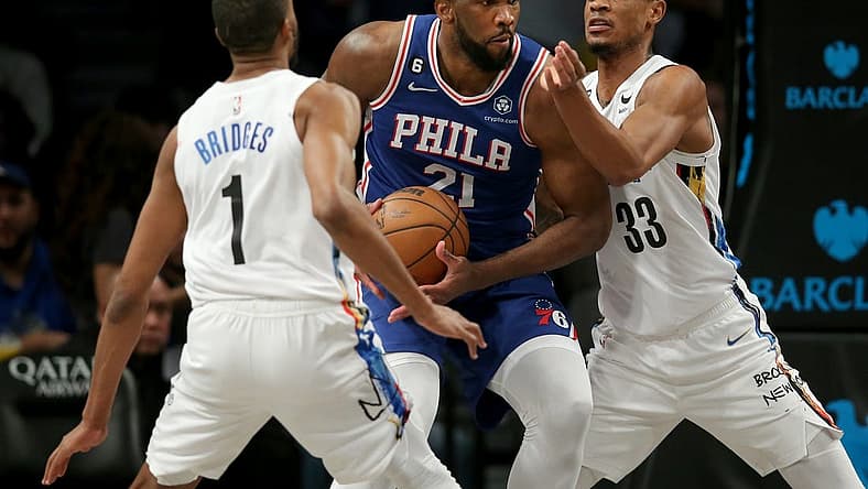 Feb 11, 2023; Brooklyn, New York, USA; Philadelphia 76ers center Joel Embiid (21) drives to the basket against Brooklyn Nets forward Mikal Bridges (1) and center Nic Claxton (33) during the third quarter at Barclays Center. Mandatory Credit: Brad Penner-USA TODAY Sports