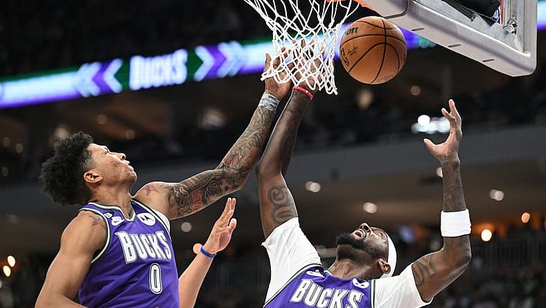 Mar 30, 2023; Milwaukee, Wisconsin, USA; Milwaukee Bucks guard MarJon Beauchamp (0) and Milwaukee Bucks forward Bobby Portis (9) battle for a rebound in the second half at Fiserv Forum. Mandatory Credit: Michael McLoone-USA TODAY Sports