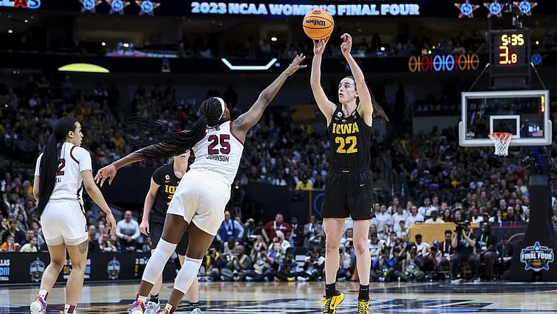 Mar 31, 2023; Dallas, TX, USA; Iowa Hawkeyes guard Caitlin Clark (22) attempts a three-point basket against South Carolina Gamecocks guard Raven Johnson (25) in the second half in semifinals of the women's Final Four of the 2023 NCAA Tournament at American Airlines Center. Mandatory Credit: Kevin Jairaj-USA TODAY Sports