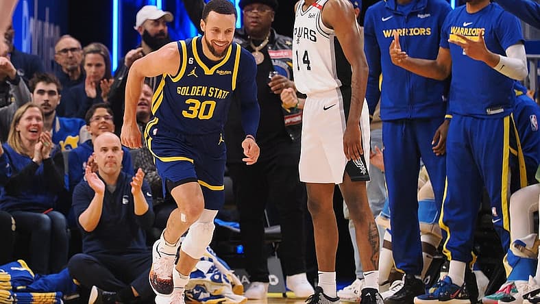 Mar 31, 2023; San Francisco, California, USA; Golden State Warriors guard Stephen Curry (30) smiles as he returns to defense after scoring a three point basket against the San Antonio Spurs during the second quarter at Chase Center. Mandatory Credit: Kelley L Cox-USA TODAY Sports