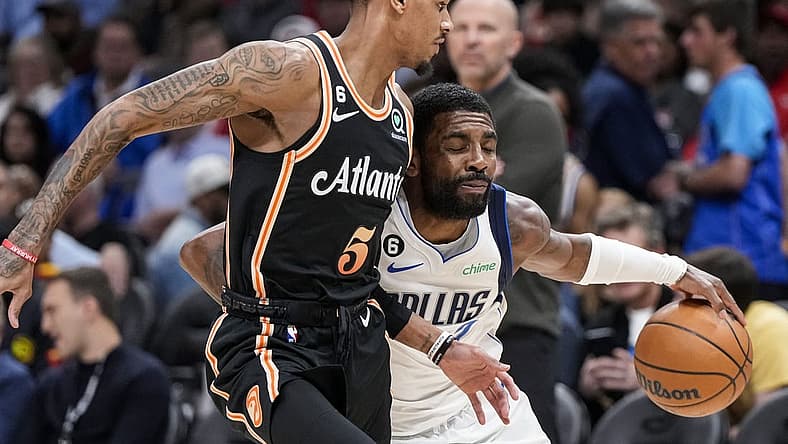 Apr 2, 2023; Atlanta, Georgia, USA; Dallas Mavericks guard Kyrie Irving (2) tries to dribble past Atlanta Hawks guard Dejounte Murray (5) during the first half at State Farm Arena. Mandatory Credit: Dale Zanine-USA TODAY Sports