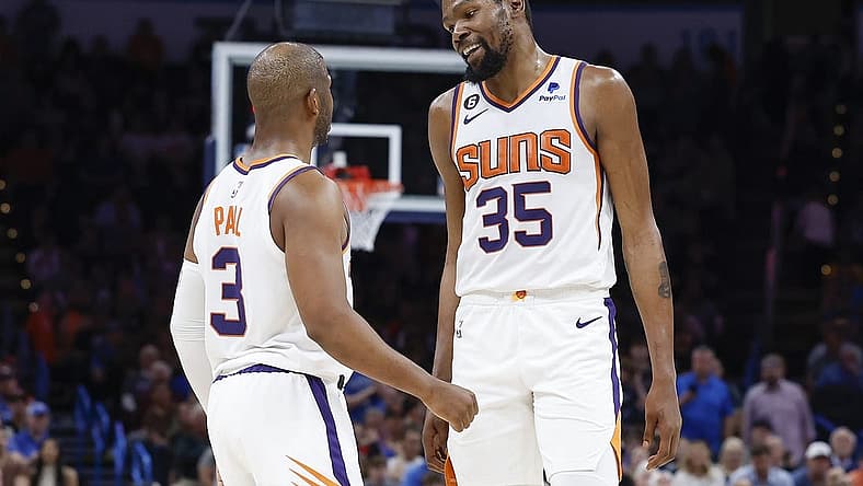 Apr 2, 2023; Oklahoma City, Oklahoma, USA; Phoenix Suns guard Chris Paul (3) and forward Kevin Durant (35) talk during the second half against the Oklahoma City Thunder at Paycom Center. Phoenix won 128-118. Mandatory Credit: Alonzo Adams-USA TODAY Sports