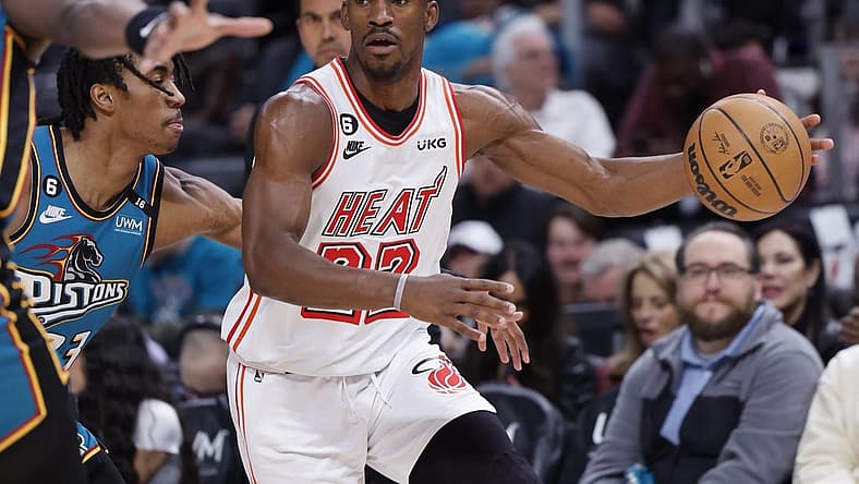 Apr 4, 2023; Detroit, Michigan, USA; Miami Heat forward Jimmy Butler (22) dribbles defended by Detroit Pistons guard Jaden Ivey (23) in the first half at Little Caesars Arena. Mandatory Credit: Rick Osentoski-USA TODAY Sports