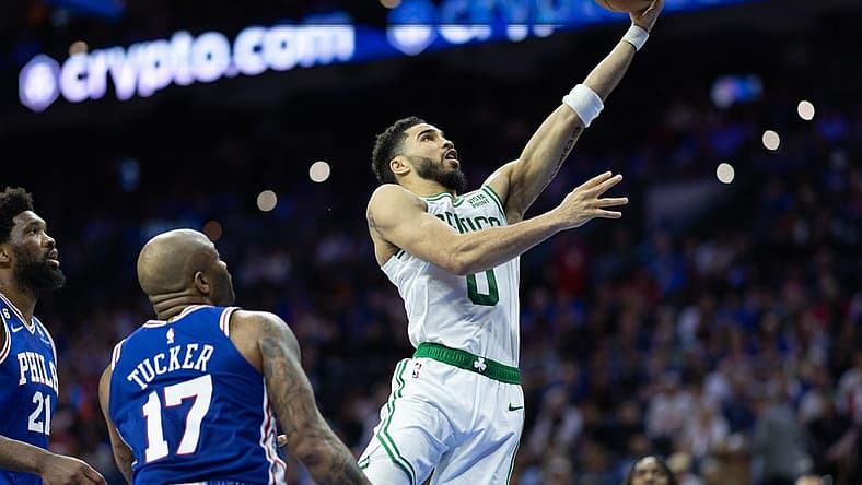 Apr 4, 2023; Philadelphia, Pennsylvania, USA; Boston Celtics forward Jayson Tatum (0) drives for a score past Philadelphia 76ers forward P.J. Tucker (17) and center Joel Embiid (21) during the second quarter at Wells Fargo Center. Mandatory Credit: Bill Streicher-USA TODAY Sports