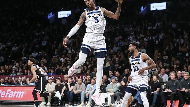 Apr 4, 2023; Brooklyn, New York, USA; Minnesota Timberwolves forward Jaden McDaniels (3) grabs a rebound in the fourth quarter against the Brooklyn Nets at Barclays Center. Mandatory Credit: Wendell Cruz-USA TODAY Sports