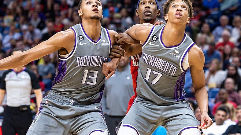 Apr 4, 2023; New Orleans, Louisiana, USA; Sacramento Kings forward Keegan Murray (13) and forward Kessler Edwards hold back New Orleans Pelicans guard Josh Richardson (2) on a rebound during the second half at Smoothie King Center. Mandatory Credit: Stephen Lew-USA TODAY Sports