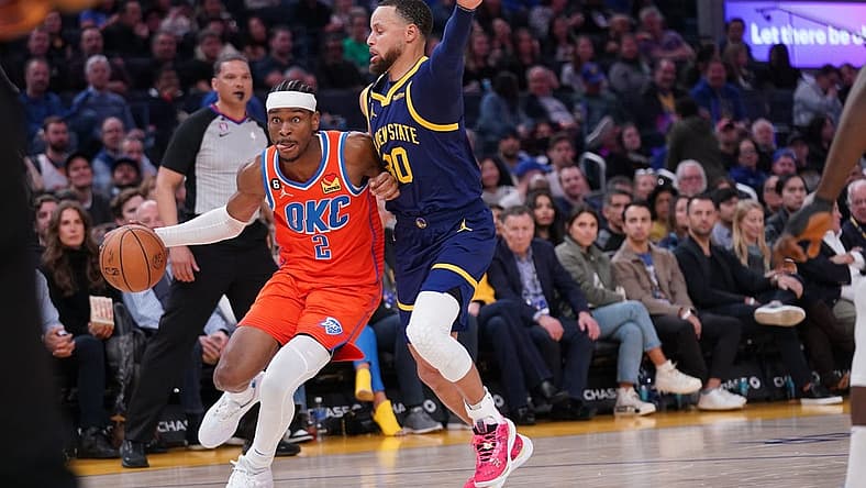 Apr 4, 2023; San Francisco, California, USA; Oklahoma City Thunder guard Shai Gilgeous-Alexander (2) dribbles the ball next to Golden State Warriors guard Stephen Curry (30) in the second quarter at the Chase Center. Mandatory Credit: Cary Edmondson-USA TODAY Sports