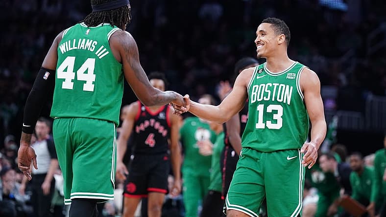 Apr 5, 2023; Boston, Massachusetts, USA; Boston Celtics guard Malcolm Brogdon (13) reacts after his three point basket with center Robert Williams III (44) against the Toronto Raptors in the second quarter at TD Garden. Mandatory Credit: David Butler II-USA TODAY Sports