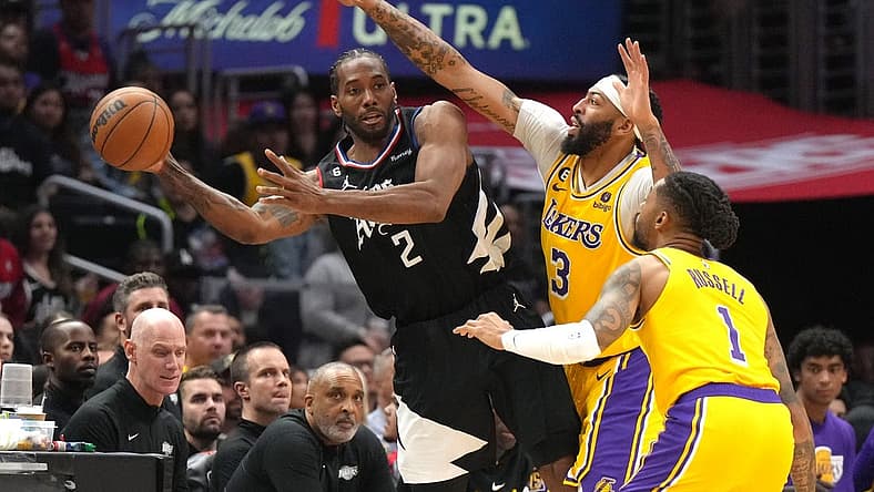 Apr 5, 2023; Los Angeles, California, USA; LA Clippers forward Kawhi Leonard (2) passes the ball against Los Angeles Lakers forward Anthony Davis (3) and guard D'Angelo Russell (1) in the second half at Crypto.com Arena. Mandatory Credit: Kirby Lee-USA TODAY Sports