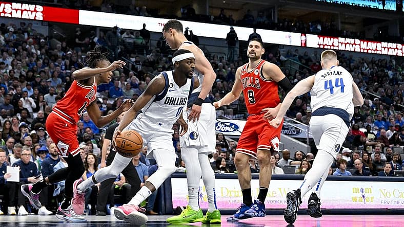Apr 7, 2023; Dallas, Texas, USA; Dallas Mavericks forward Justin Holiday (0) grabs a rebound against the Chicago Bulls during the first quarter at the American Airlines Center. Mandatory Credit: Jerome Miron-USA TODAY Sports